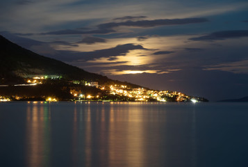 Naklejka na ściany i meble Omis city view near the mountain in Croatia at evening.