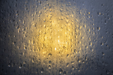 Water drop on glass light background