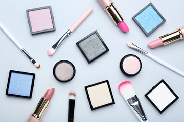 Different makeup cosmetics on grey background