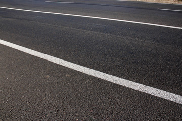 Asphalt road with marking lines white stripes