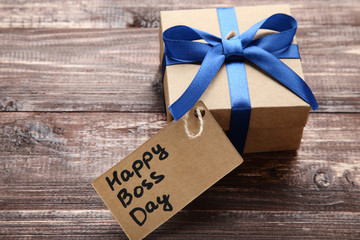Inscription Happy Boss day on paper with gift box