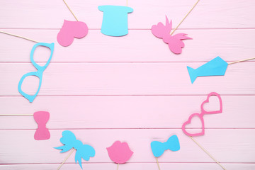 Paper booth props for party on pink wooden table