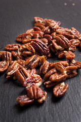 Heap of Pecan Nuts (selective focus) on an slate