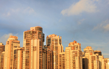 Fototapeta na wymiar Modern Residential Apartment Building or Condominium in the Suburbs of Saint Petersburg City, Russia. Skyscraper Facade of Office Building, New Complex of Tall Houses with Empty Sky Background on Dusk