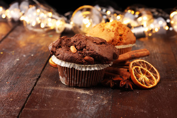 Chocolate muffin and nut muffin, homemade bakery on dark background.