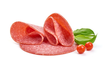 Turkey smoked salami with basil leaves and Physalia berries, close-up, isolated on a white background