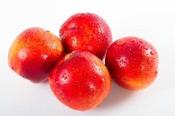 Red nectarines super fruit, high energy antioxidant food, health booster juicy red mediterranean nectarines isolated on white background. 