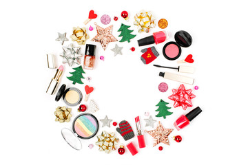 Christmas frame made from winter decorations and cosmetic products on white background. Holiday and celebration creative concept. Flat lay, top view