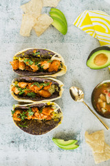 Double-stacked blue corn and flour tortillas tacos