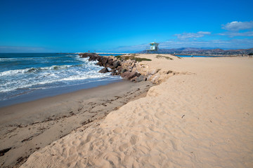 Lifeguard tower and rock jetty seawall in Ventura California United States