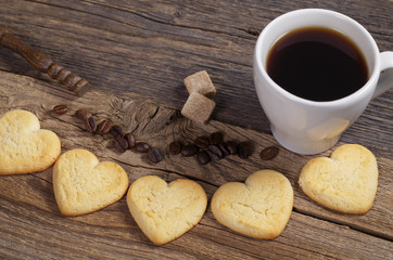 Homemade cookies in the shape of a heart and coffee