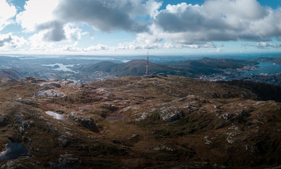 Aerial Drone Panorama View of Bergen City Norway with Ulriken Mountain Peak and Radio Antenna Landscape