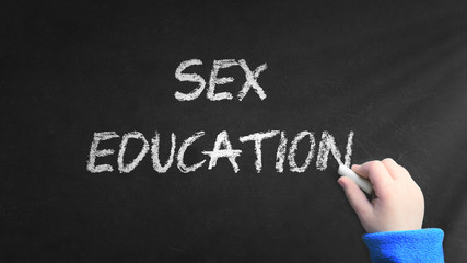 Fototapeta premium Sex education word written on a blackboard in a classroom during a sexual lecture at school. Empty copy space for Editor's text.