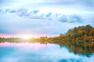 Fototapeta premium Symmetry reflection on the autumn river. Sunrise.