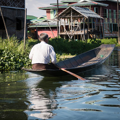man paddling in his canoe in inle lake in myanmar