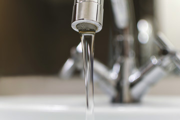 modern сhrome faucet with jet. closeup.