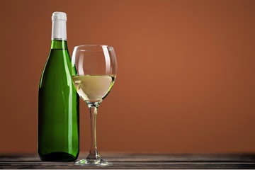 Red wine glass and buttle on wooden