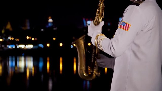 saxophonist plays at night by the river