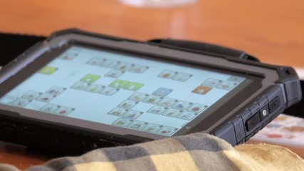 Child using a Augmented and Alternative Communication Device. Speech assist software and protective hard case.