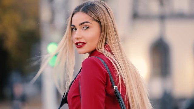 Sexy charismatic lady with red lips go away turning face looking at me