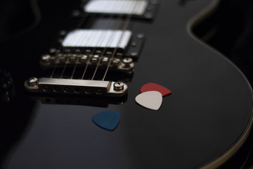 black guitar with mediators