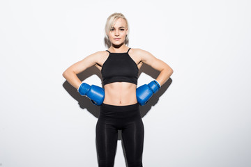 Fototapeta premium Young boxing Woman on white background. Boxer woman during boxing exercise. Girl training body combat. Woman boxer boxing isolated on white background