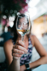 Woman's hands holding a glass of white wine