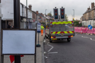 White board on the background of road works. Blurred background.