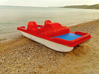 A red boat on the Greek seashore