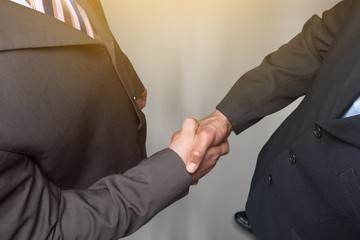 Business people handshaking at meeting on background