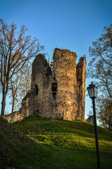 Beautiful afternoon light in public park with green grass and old medieval castle ruins. Shot in Cesis, Latvia.
