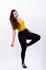 Fototapeta na wymiar Full body shot of young beautiful Indian woman posing while thin