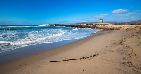 Lifeguard tower and rock jetty seawall in Ventura California United States