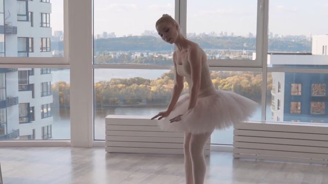 a young ballerina rehearses a dance number in a ballet hall. the woman is spinning in place Slowmotion