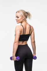 Fototapeta premium portrait of pretty sporty woman holding weights isolated on gray background