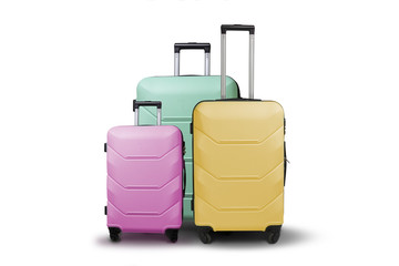 Three multi-colored plastic suitcases on wheels on a white isolated background. Travel concept, vacation trip, visit to relatives
