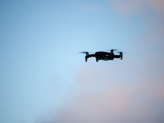 Drone hovering against Blue sky.
