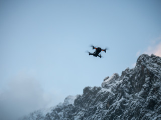 Fototapeta na wymiar Drone hovering against Blue sky.