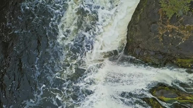Full water stream with foam and rocks