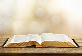 Open book on old wooden table