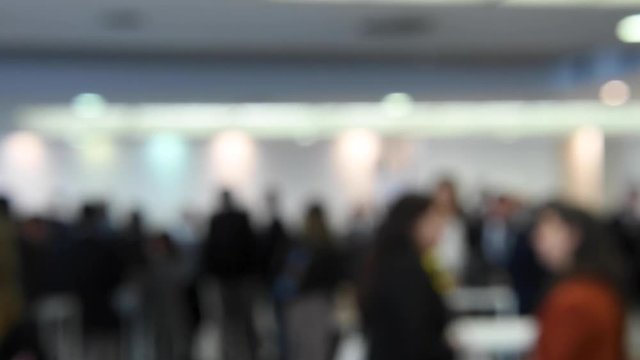 Business people networking in a conference hall during a business meeting. Intentionally blurred 