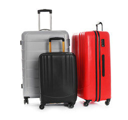 Modern suitcases for travelling on white background