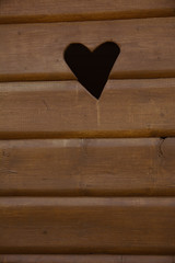 Fototapeta premium Close-up of typical old wooden outhouse with heart in the middle