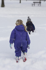 Fototapeta na wymiar Children playing in the snow 