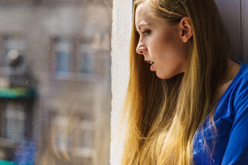 Shocked teenage woman looking through