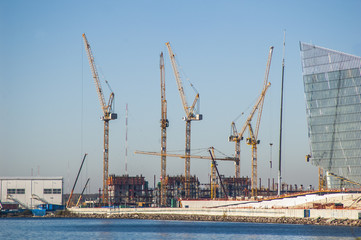 Fototapeta premium Hoisting cranes near the northern sea. Saint-Petersburg.