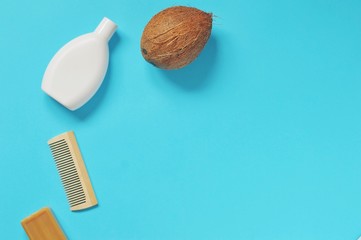 Coconut oil based cosmetics. Shampoo bottle, wooden hair brush, soap bar and coconut. Organic bath...