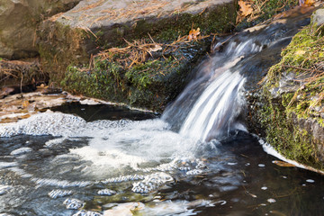 small waterfall in the forest creek 