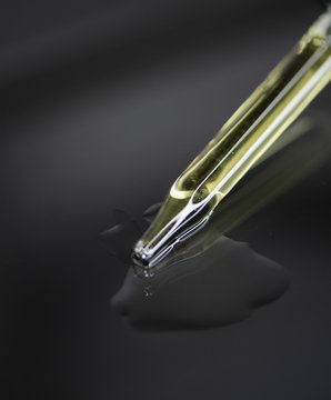Glass Pipette for Skincare on Black Grey Background