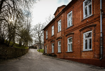 Fototapeta na wymiar Old brick building in the city center. Shot taken in Kandava, Latvia. No people in the photo.